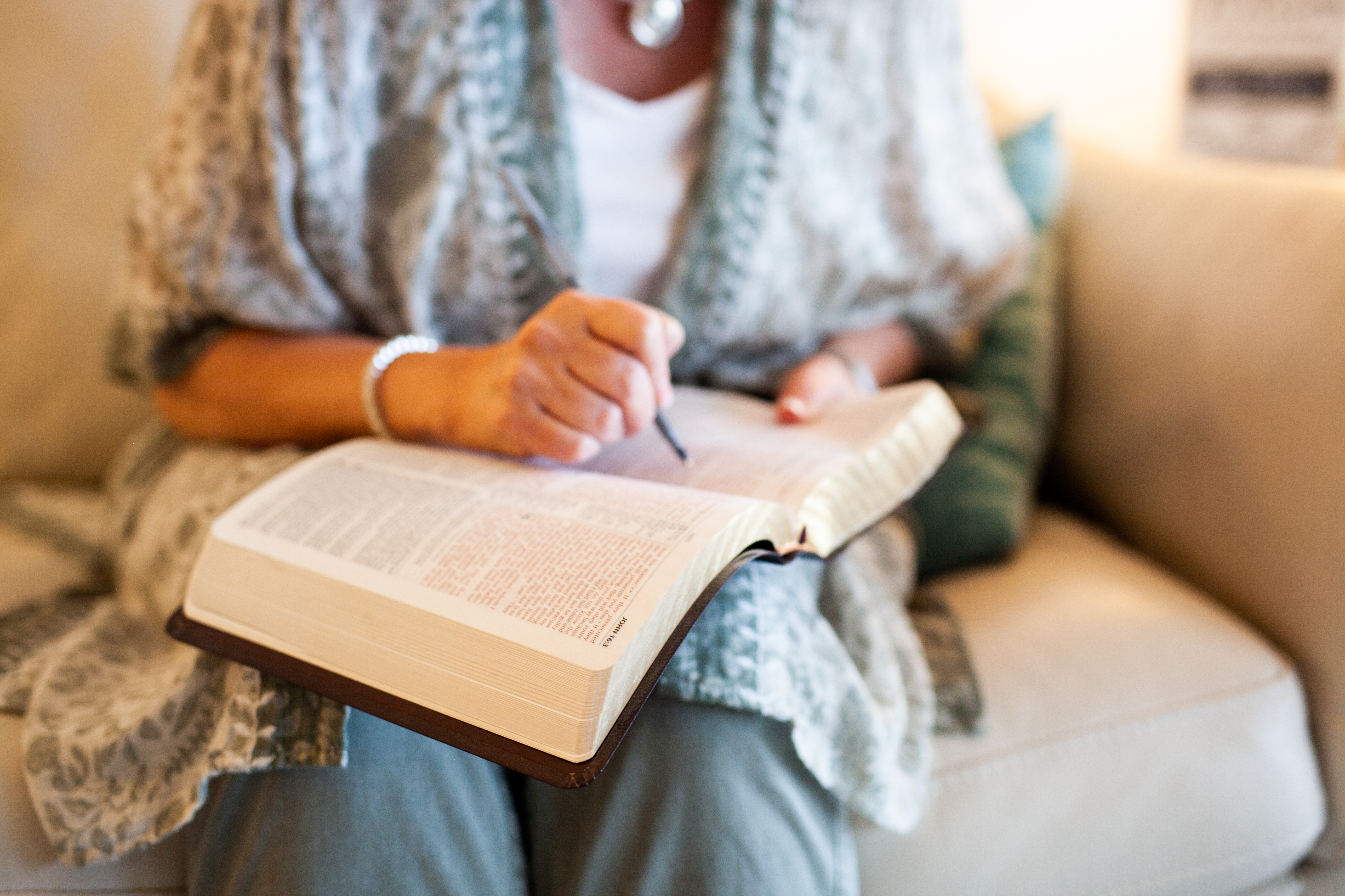 person holding brown framed eyeglasses